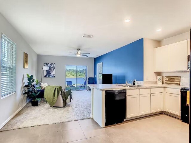 10024 Merry Fawn Ct, Sun City Center, FL 33573 - kitchen with black appliances, a peninsula, white cabinets, ceiling fan, and light countertops
