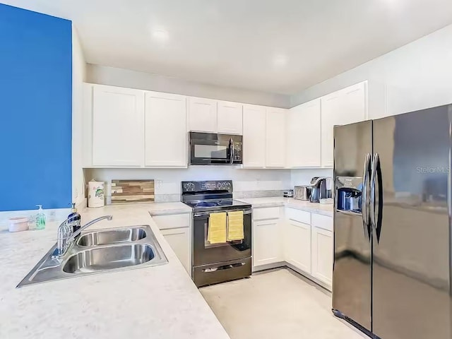10024 Merry Fawn Ct, Sun City Center, FL 33573 - kitchen with black appliances, light countertops, and white cabinets