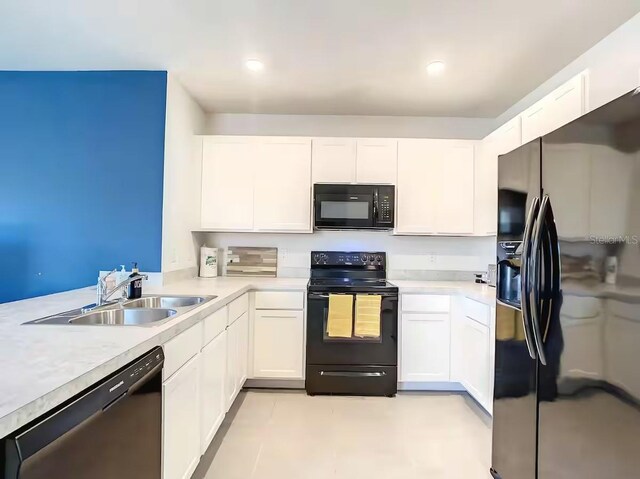 10024 Merry Fawn Ct, Sun City Center, FL 33573 - kitchen with black appliances, light countertops, white cabinetry, and a peninsula