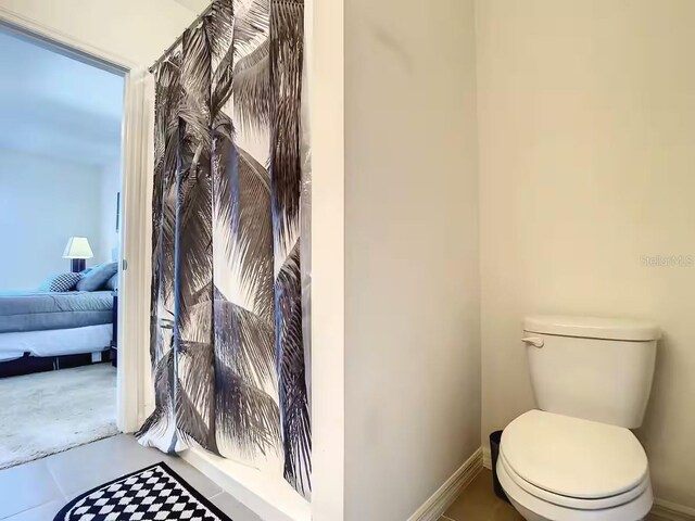 10024 Merry Fawn Ct, Sun City Center, FL 33573 - bathroom featuring toilet and baseboards