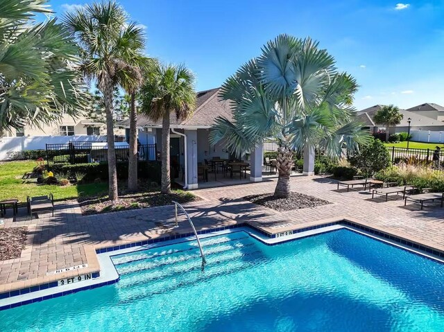 10024 Merry Fawn Ct, Sun City Center, FL 33573 - community pool featuring a patio