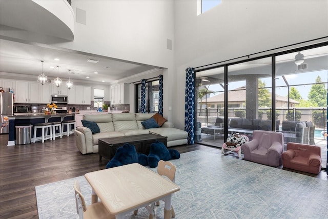 12415 Hitching St, Odessa, FL 33556 - living area with dark wood-style flooring, ornamental molding, healthy amount of natural light, a high ceiling, and recessed lighting