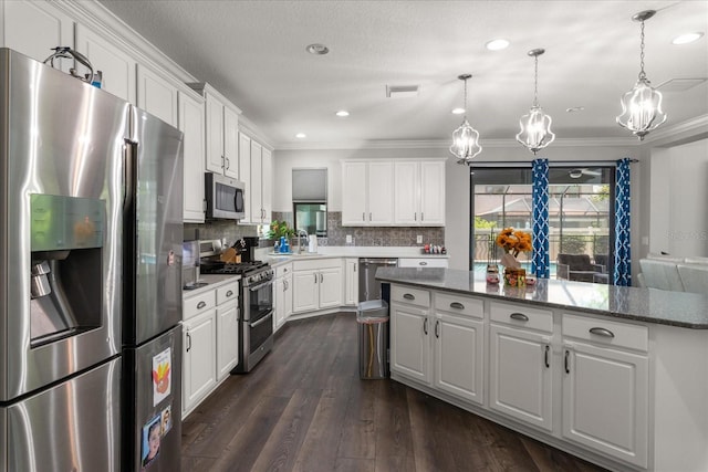 12415 Hitching St, Odessa, FL 33556 - kitchen featuring stainless steel appliances, a chandelier, ornamental molding, white cabinetry, and backsplash