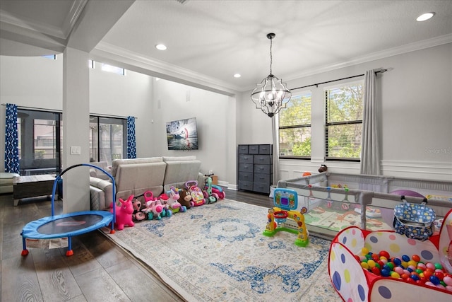12415 Hitching St, Odessa, FL 33556 - game room with ornamental molding, wood finished floors, healthy amount of natural light, recessed lighting, and a chandelier