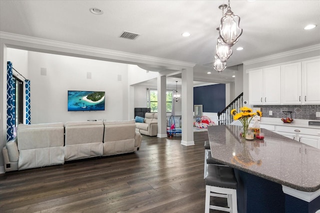 12415 Hitching St, Odessa, FL 33556 - kitchen featuring a chandelier, open floor plan, ornamental molding, white cabinets, and dark wood-style floors