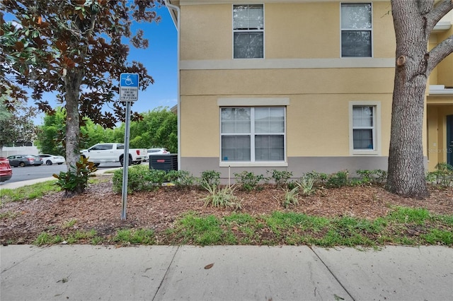 3455 Castle Stone Ct, Valrico, FL 33594 - view of property exterior with stucco siding and a cooling unit