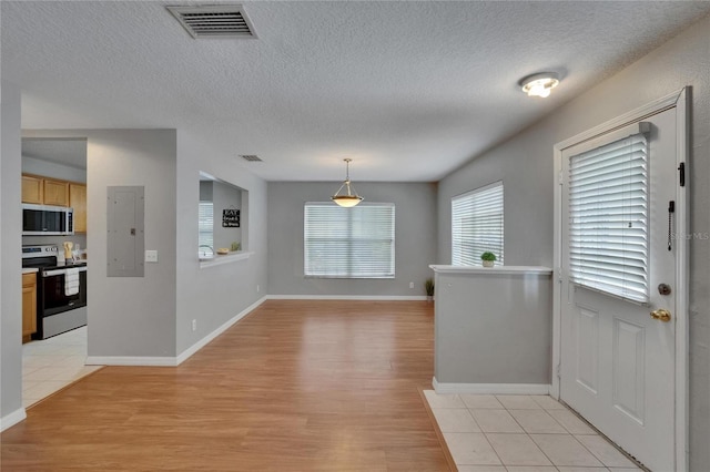 3455 Castle Stone Ct, Valrico, FL 33594 - entrance foyer featuring electric panel, light wood finished floors, and a textured ceiling