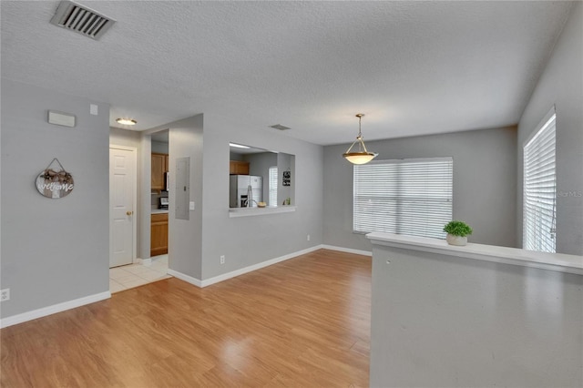 3455 Castle Stone Ct, Valrico, FL 33594 - unfurnished room featuring light wood-style flooring and a textured ceiling