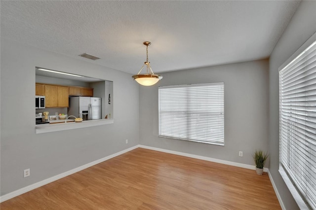 3455 Castle Stone Ct, Valrico, FL 33594 - unfurnished living room with light wood finished floors and healthy amount of natural light