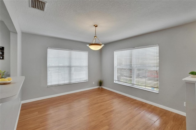 3455 Castle Stone Ct, Valrico, FL 33594 - unfurnished dining area featuring wood finished floors and a textured ceiling