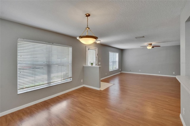 3455 Castle Stone Ct, Valrico, FL 33594 - unfurnished room with a ceiling fan, light wood-style floors, and a textured ceiling