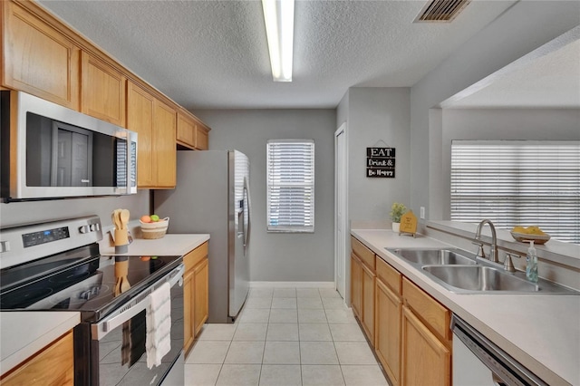 3455 Castle Stone Ct, Valrico, FL 33594 - kitchen with stainless steel appliances, a textured ceiling, light countertops, and light tile patterned floors