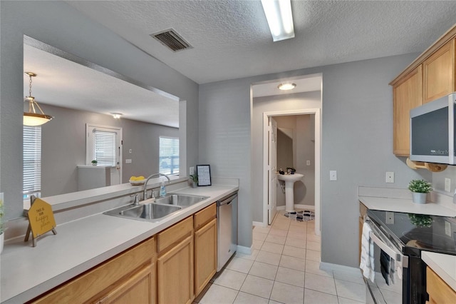 3455 Castle Stone Ct, Valrico, FL 33594 - kitchen with stainless steel appliances, light tile patterned floors, light countertops, a textured ceiling, and decorative light fixtures