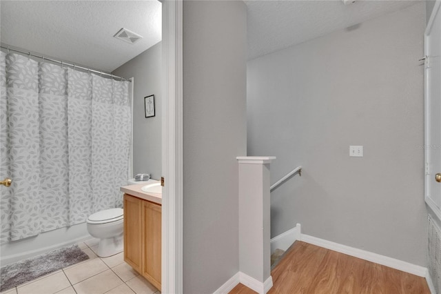 3455 Castle Stone Ct, Valrico, FL 33594 - bathroom with vanity, a textured ceiling, and shower / bath combo with shower curtain