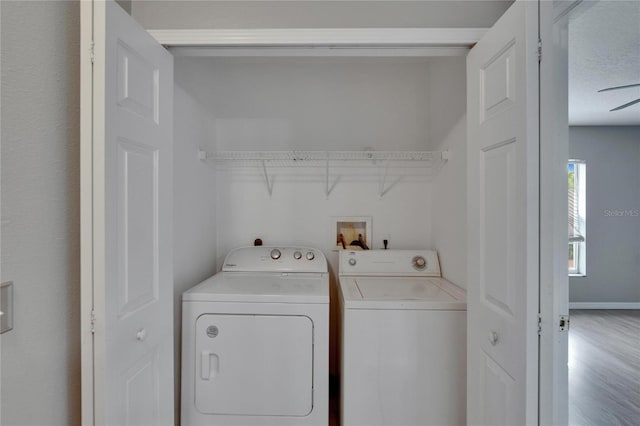 3455 Castle Stone Ct, Valrico, FL 33594 - laundry room with separate washer and dryer and wood finished floors
