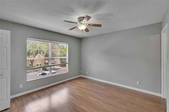 3455 Castle Stone Ct, Valrico, FL 33594 - spare room featuring ceiling fan, wood finished floors, and a textured ceiling