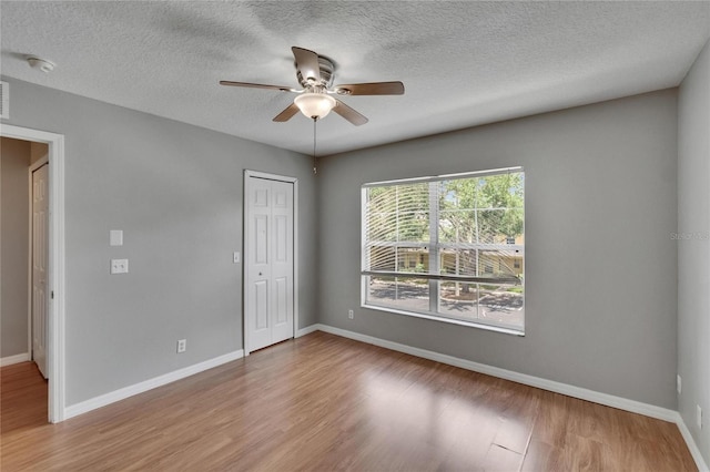 3455 Castle Stone Ct, Valrico, FL 33594 - unfurnished room featuring wood finished floors, ceiling fan, a textured ceiling, and a smoke detector