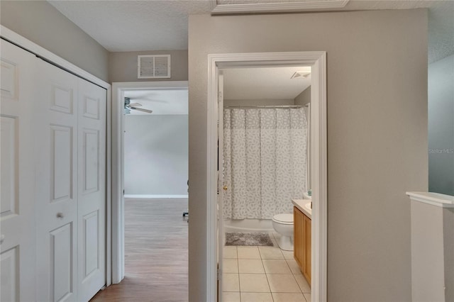 3455 Castle Stone Ct, Valrico, FL 33594 - full bath featuring vanity, a shower with curtain, tile patterned floors, and a ceiling fan