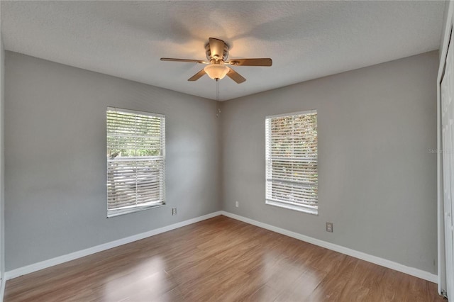 3455 Castle Stone Ct, Valrico, FL 33594 - empty room with a ceiling fan, wood finished floors, and a textured ceiling