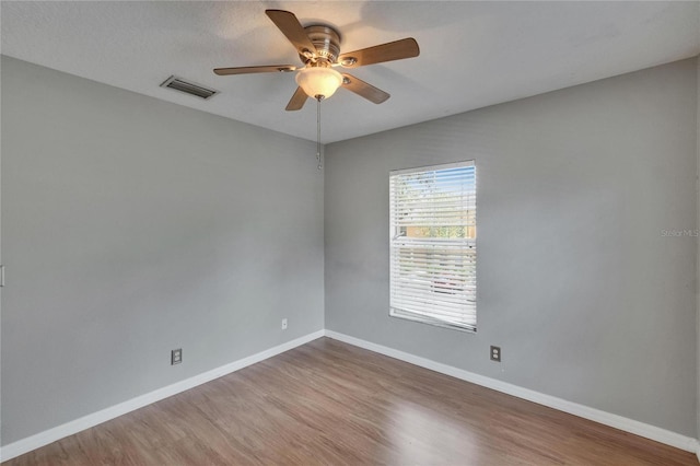 3455 Castle Stone Ct, Valrico, FL 33594 - empty room with wood finished floors and a ceiling fan
