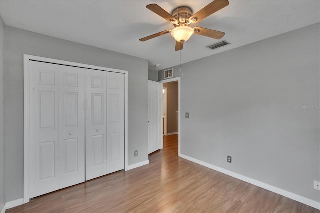 3455 Castle Stone Ct, Valrico, FL 33594 - unfurnished bedroom featuring light wood finished floors, a closet, and a ceiling fan