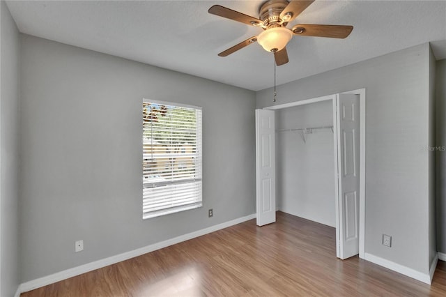 3455 Castle Stone Ct, Valrico, FL 33594 - unfurnished bedroom featuring wood finished floors, a closet, and a ceiling fan
