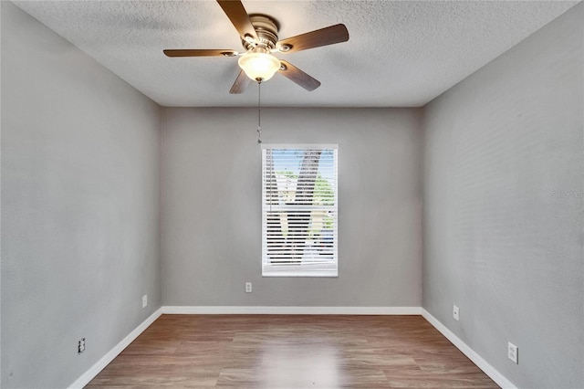 3455 Castle Stone Ct, Valrico, FL 33594 - spare room with a textured ceiling, a ceiling fan, and wood finished floors