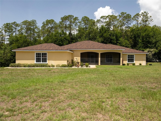 21590 SW 84th Loop, Dunnellon, FL 34431 - ranch-style home with a front yard, stucco siding, and a sunroom