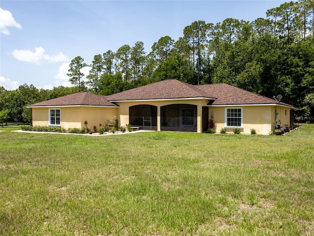 21590 SW 84th Loop, Dunnellon, FL 34431 - view of front of home featuring a sunroom, a front lawn, and stucco siding