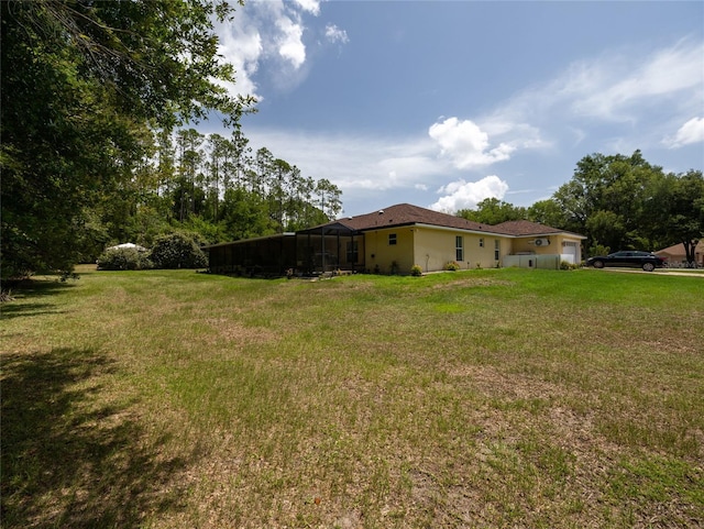 21590 SW 84th Loop, Dunnellon, FL 34431 - view of grassy yard featuring an attached garage and a lanai