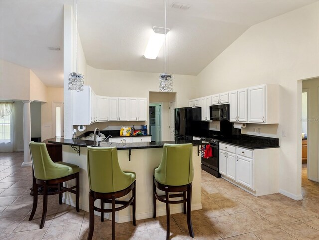 21590 SW 84th Loop, Dunnellon, FL 34431 - kitchen featuring black appliances, high vaulted ceiling, a peninsula, a breakfast bar, and white cabinetry