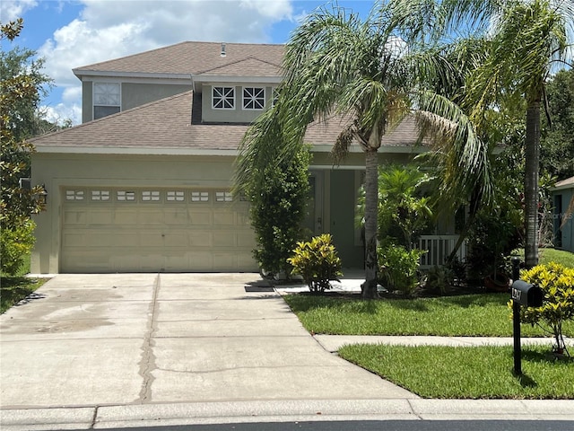 1247 Gentilly Ln, Wesley Chapel, FL 33544 - view of front of property featuring concrete driveway, a shingled roof, stucco siding, and a garage