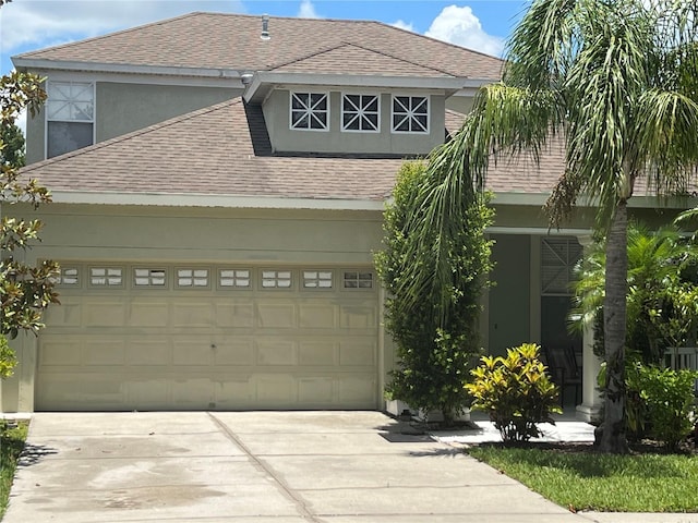 1247 Gentilly Ln, Wesley Chapel, FL 33544 - view of front facade with roof with shingles, concrete driveway, and stucco siding