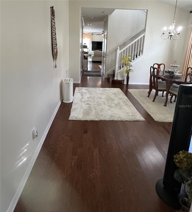 1247 Gentilly Ln, Wesley Chapel, FL 33544 - corridor featuring stairs, dark wood-style flooring, and a chandelier