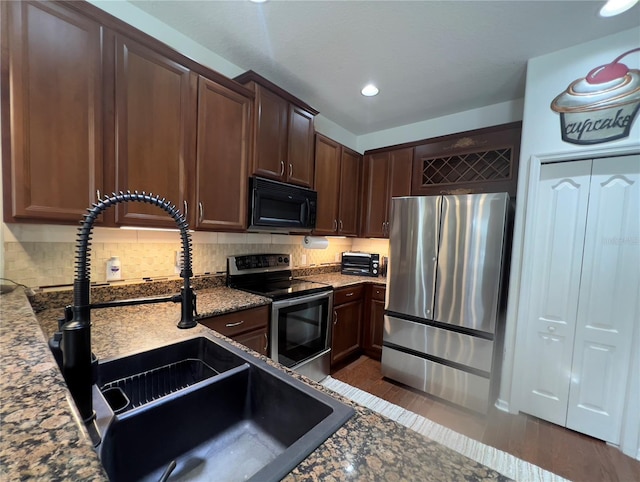 1247 Gentilly Ln, Wesley Chapel, FL 33544 - kitchen featuring stainless steel appliances, backsplash, dark brown cabinets, and recessed lighting