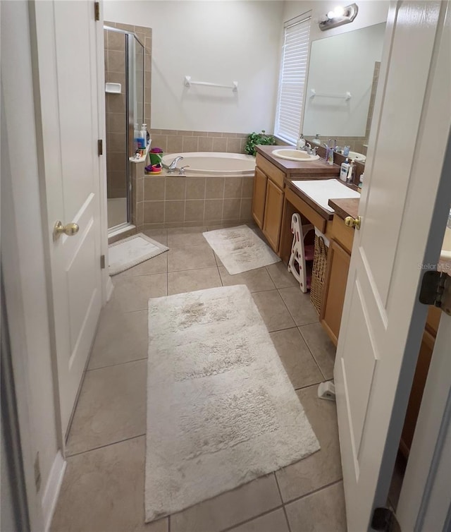 1247 Gentilly Ln, Wesley Chapel, FL 33544 - full bathroom featuring a garden tub, vanity, a shower stall, and tile patterned flooring