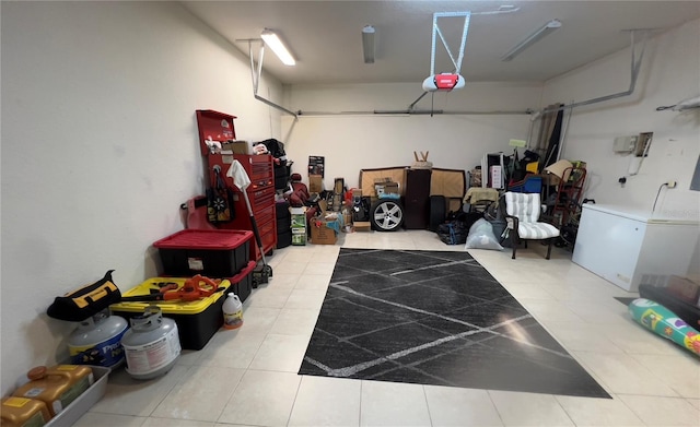 1247 Gentilly Ln, Wesley Chapel, FL 33544 - garage featuring freestanding refrigerator and a garage door opener