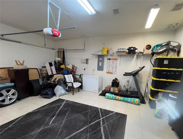 1247 Gentilly Ln, Wesley Chapel, FL 33544 - garage featuring a garage door opener, fridge, and electric panel