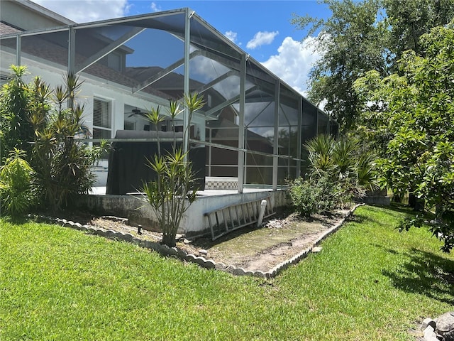 1247 Gentilly Ln, Wesley Chapel, FL 33544 - view of side of home with a lawn, a ceiling fan, and a lanai