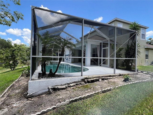 1247 Gentilly Ln, Wesley Chapel, FL 33544 - back of property with a patio, an outdoor pool, a lanai, and stucco siding