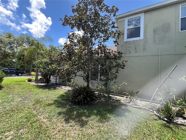 1247 Gentilly Ln, Wesley Chapel, FL 33544 - view of side of home with a yard and stucco siding