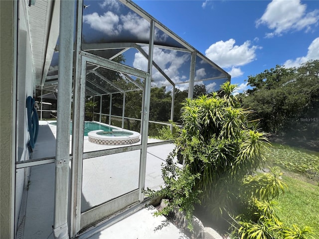 1247 Gentilly Ln, Wesley Chapel, FL 33544 - view of pool with a pool with connected hot tub, glass enclosure, and a patio