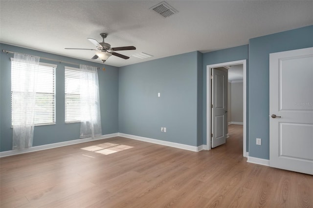 4146 Bexley Village Dr, Land O Lakes, FL 34638 - unfurnished room featuring a ceiling fan, light wood-type flooring, and a textured ceiling