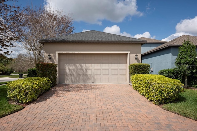 4146 Bexley Village Dr, Land O Lakes, FL 34638 - view of front facade featuring stucco siding, decorative driveway, an attached garage, and roof with shingles