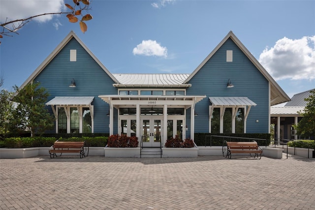 4146 Bexley Village Dr, Land O Lakes, FL 34638 - rear view of property with french doors, a metal roof, and a standing seam roof