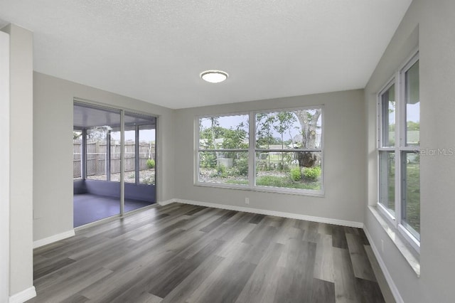7625 Marechal Ave, Port Richey, FL 34668 - unfurnished sunroom with wood finished floors and baseboards