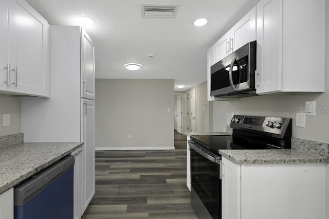 7625 Marechal Ave, Port Richey, FL 34668 - kitchen with black electric range, stainless steel microwave, dishwashing machine, white cabinetry, and dark wood-type flooring