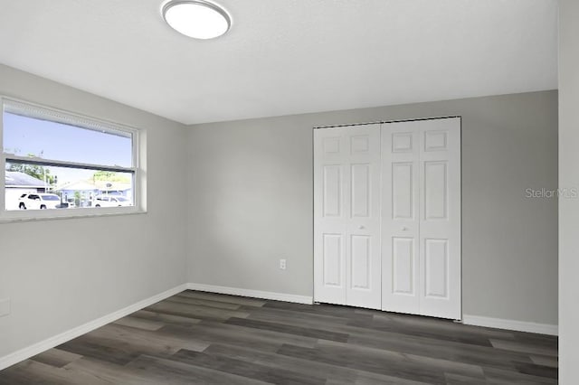7625 Marechal Ave, Port Richey, FL 34668 - unfurnished bedroom featuring dark wood-style floors and a closet
