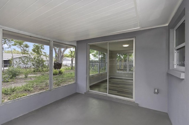 7625 Marechal Ave, Port Richey, FL 34668 - unfurnished sunroom with healthy amount of natural light and concrete floors