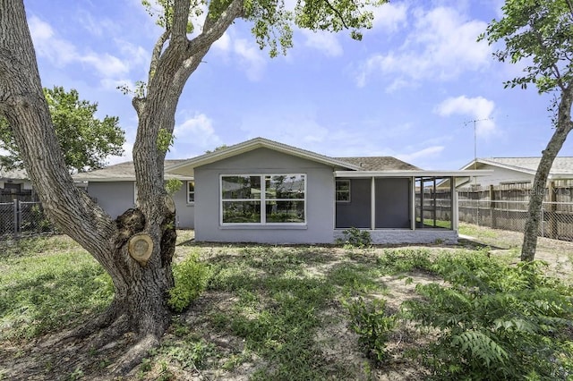 7625 Marechal Ave, Port Richey, FL 34668 - back of house featuring stucco siding and a sunroom